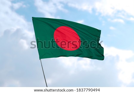 Flag of Bangladesh in front of blue sky