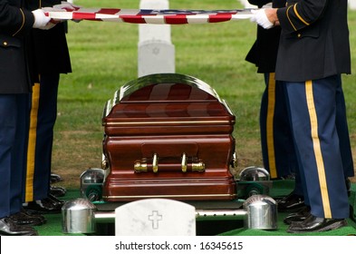 Flag Being Lifted From Casket During Burial At Arlington National Cemetery