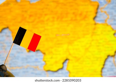 Flag of Belgium on the background of the map of Belgium. - Shutterstock ID 2281090203