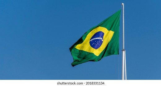 Flag of Brazil fluttering in the wind. In the center of the flag with the words "order and progress" in Portuguese. flag day. proclamation of the Republic. proclamação da república