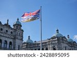 Flag of British Columbia waving in front of the Legislative Assembly of British Columbia Parliament Building on Vancouver Island in Victoria, British Columbia, Canada