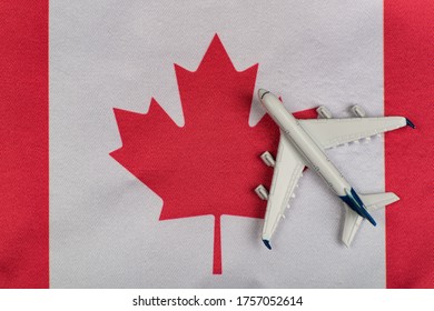 Flag Of Canada And Model Airplane. Flights To Canada After Quarantine. Resumption Of Flights.