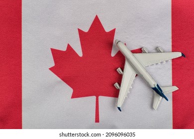 Flag of Canada and model airplane. Flights to Canada after quarantine. Resumption of flights.