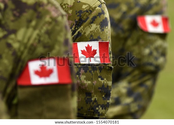 Flag of Canada on military\
uniform. Canadian soldiers. Army of Canada. Remembrance Day. Canada\
Day.