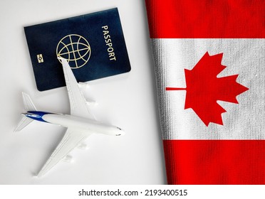 Flag of Canada with passport and toy airplane. Flight travel concep - Shutterstock ID 2193400515