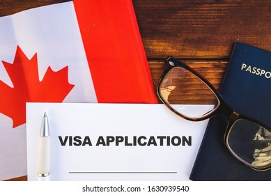 Flag Of Canada, Visa Application Form And Passport On Table