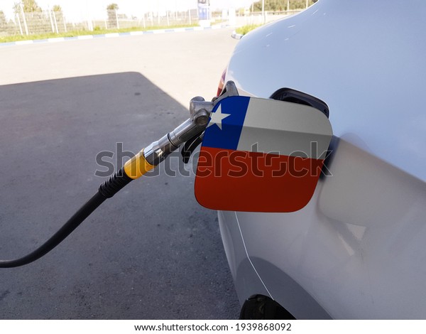 Flag of Chile on the car\'s\
fuel tank filler flap. Petrol station. Fueling car at a gas\
station.