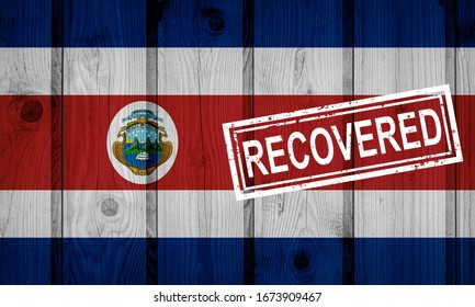 flag of Costa Rica that survived or recovered from the infections of corona virus epidemic or coronavirus. Grunge flag with stamp Recovered