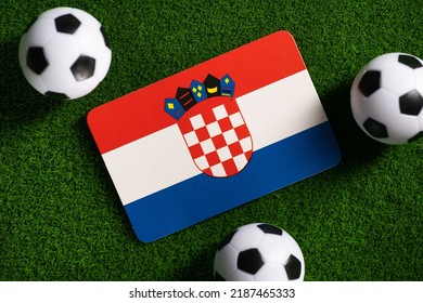 Flag Of Croatia. Football Balls On A Green Lawn. World Cup 2022. Top View.