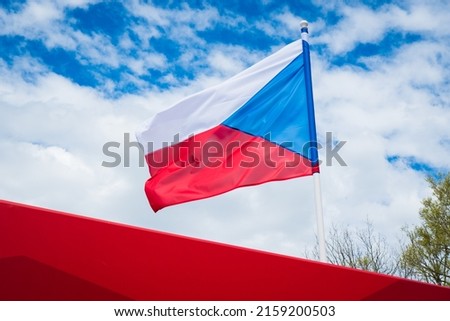 Flag of Czech Republic on white cloudy sky background. Czech flag waving in wind. 