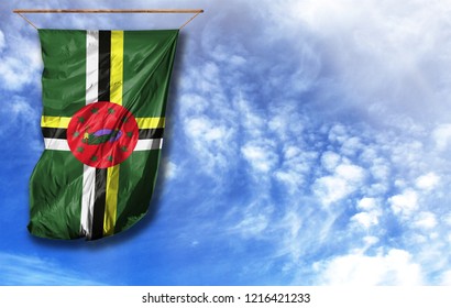 Flag Of Dominica. Vertical Flag, Against Blue Sky With Place For Your Text