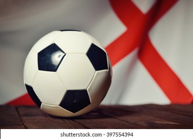 Flag of England with football on wooden boards as the background. MANY OTHER PHOTOS FROM THIS SERIES IN MY PORTFOLIO.