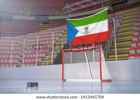 Flag of Equatorial Guinea in hockey arena with puck and net