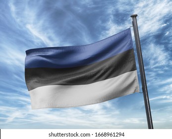 Flag of Estonia on Flag Pole in Blue Sky. Estonia Flag for advertising, celebration, achievement, festival, election. The symbol of the state on wavy cotton fabric.