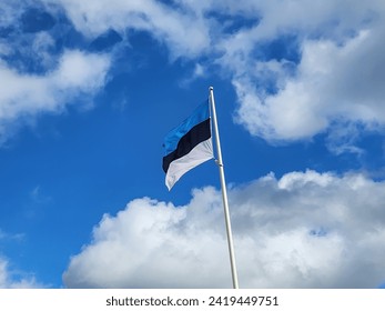 The flag of Estonia is a tricolour flag consisting of three equal horizontal bands of blue, black, and white, symbolizing freedom and national identity in the European country of Estonia. - Powered by Shutterstock