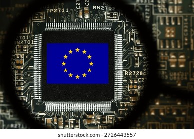 Flag of EU on a processor. Computer board with chip. View through magnifying glass