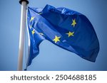 Flag of the European Union in front of a blue blue sky