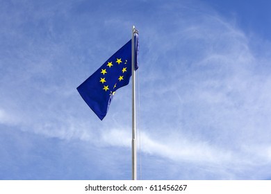 Flag of European Union on a flagpole in front of blue sky - Shutterstock ID 611456267
