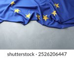 Flag of European Union on light grey table, above view