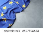 Flag of European Union on light grey table, top view. Space for text