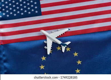 Flag of European Union and USA with toy airplane. Concept of flights from Europe to United States of America