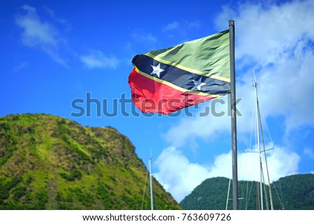 Flag of the Federation of St Kitts and Nevis floating on a mast