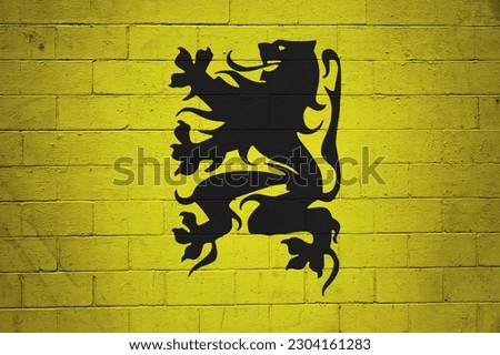 Flag of Flanders (Belgium) painted on a cinder block wall.