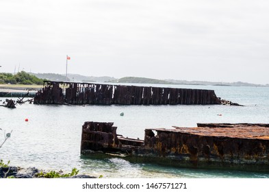 The Flag Flies Beyond The Remains Of A Shipwreck In Bermuda