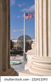 Flag flying between two pillars of the Supreme Court of the United States