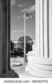 Flag flying between two pillars of the Supreme Court of the United States