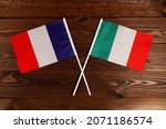 Flag of France and flag of Italy crossed with each other. The image illustrates the relationship between countries. Photography for video news on TV and articles on the Internet and media.