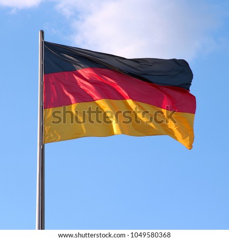 Similar – Waving German flag in front of a blue sky with clouds, Hallig Oland in the background