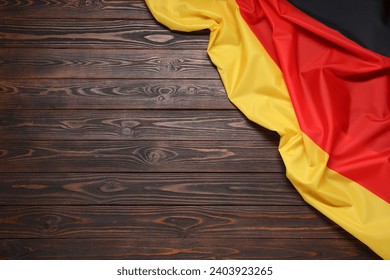 Flag of Germany on dark wooden background, top view. Space for text - Powered by Shutterstock