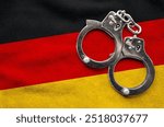 Flag of Germany and police handcuffs. Crime and offenses in country Concept 