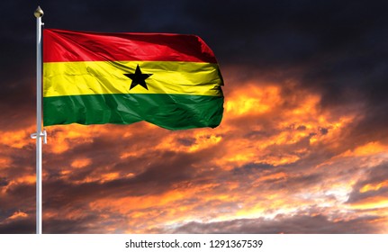 flag of Ghana on flagpole fluttering in the wind against a colorful sunset sky - Powered by Shutterstock