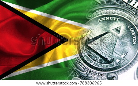 Flag of Guyana on a fabric with an American dollar close-up.