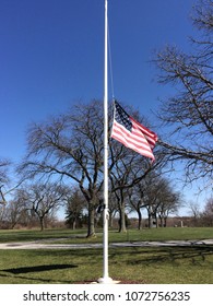 flag at half-staff with blue sky