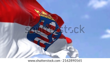 The flag of Hesse waving in the wind on a clear day. Hesse is a state in Germany. Its capital city is Wiesbaden, and the largest urban area is Frankfurt Stock photo © 