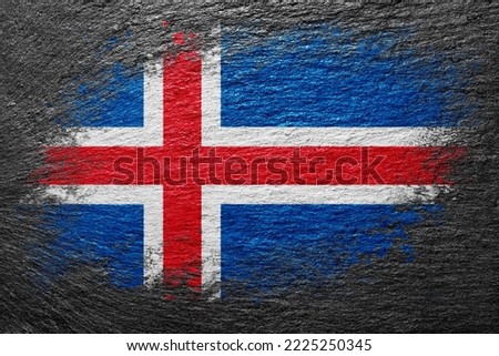 Flag of Iceland. Flag is painted on a stone surface. Stone background. Black slate background. Creative background