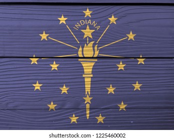 Flag Of Indiana On Wooden Wall Background. Grunge Indiana Flag Texture, The States Of America, A Gold Torch Surrounded By An Outer Circle Of Stars, An Inner Semi Circle Of Stars.