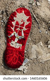 The Flag Of Isle Of Man Is Depicted On The Sole Of An Old Boot. Ecology Concept With Environmental Pollution From Household And Industrial Waste.