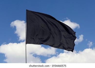 Flag Isolated On Sky Background With Clipping Path. Black Flag Pattern On The Fabric Texture. Black Fabric Texture For Background.