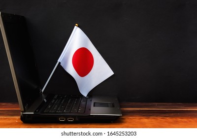 Flag Of Japan , Computer, Laptop On Table And Dark Background