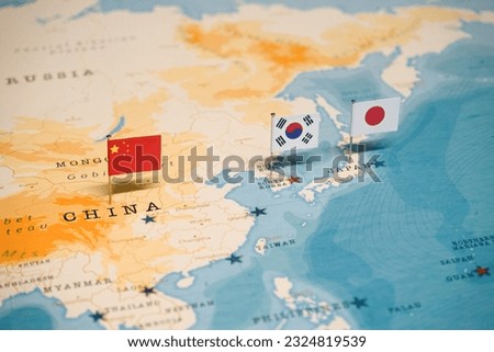 The Flag of Korea and China and Japan on the World Map.