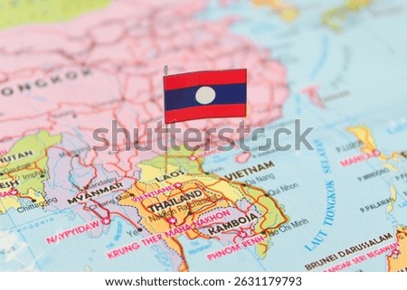 The flag of Laos is planted on a map showing the country's territory. It clearly highlights the geographic location of Laos. This illustration shows Laos as a landlocked country in Southeast Asia