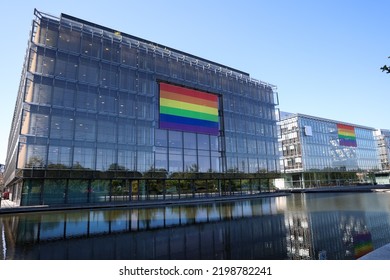 Flag Of The LGBT Community On An Office Building. Pride LGBT. The River Is Next To The Building.