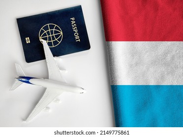 Flag Of Luxembourg With Passport And Toy Airplane. Flight Travel Concept 