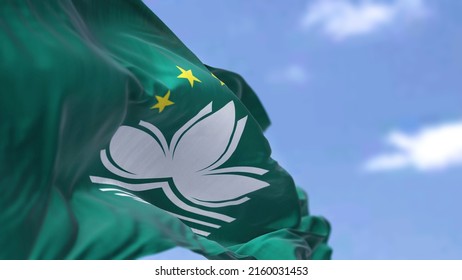 The flag of Macau waving in the wind on a clear day. Macau is a city and special administrative region of China