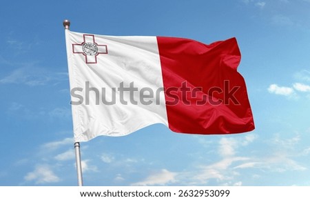 The flag of Malta is shown waving in the wind, featuring white and red fields and the George Cross in the corner.