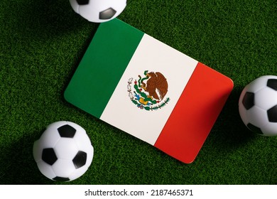 Flag Of Mexico. Football Balls On A Green Lawn. World Cup 2022. Top View.